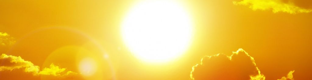 Sunshine over clouds in an orange sky during a heatwave.